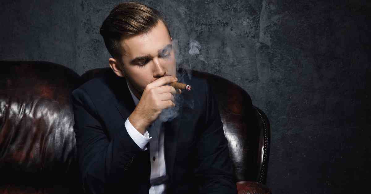 Elegancki mężczyzna pali cygaro