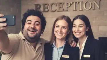 Narcyz robi sobie selfie z recepcjonistkami hotelu